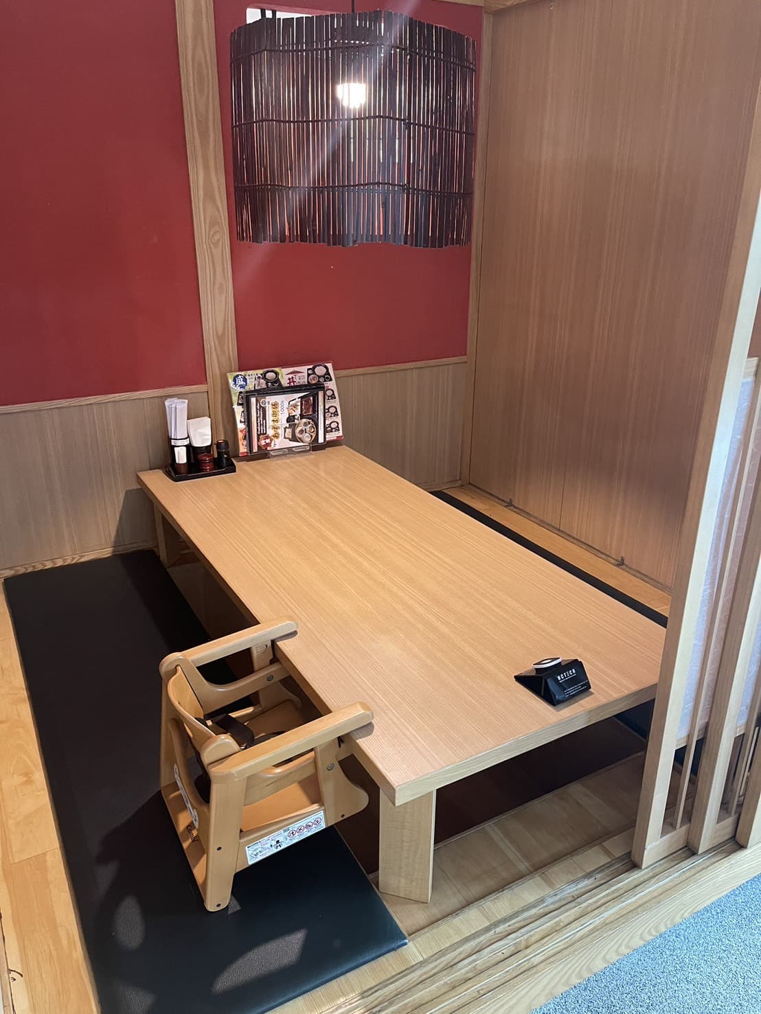 Japanese restaurant table with booth seating and a child seat