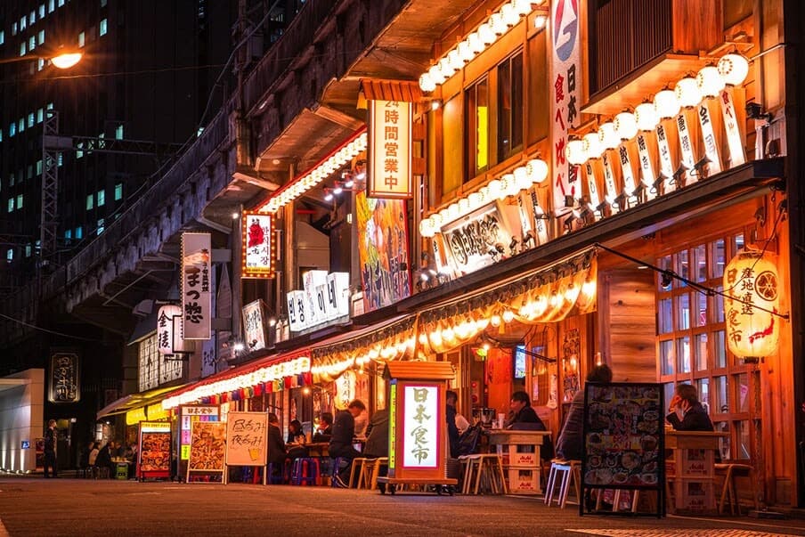 Tokyo restaurant street at night with lanterns and dining signs