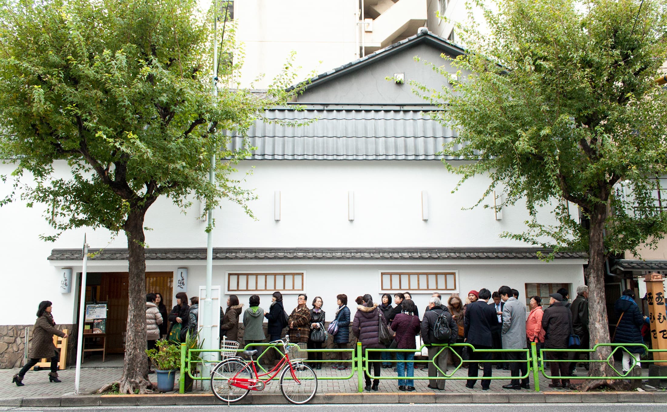 People waiting outside a Japanese restaurant before opening