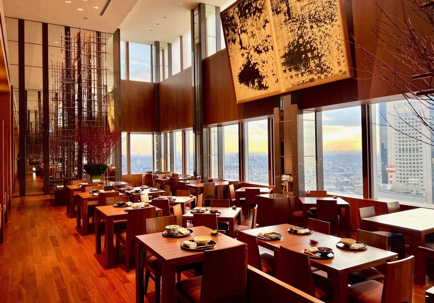 Japanese restaurant dining room with city views and prepared tables