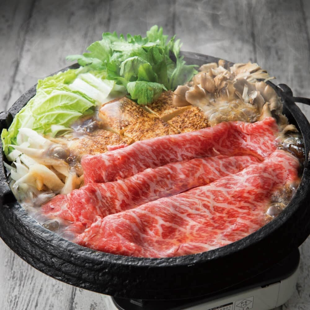 Wagyu beef cooking in a Japanese-style hot pot with vegetables
